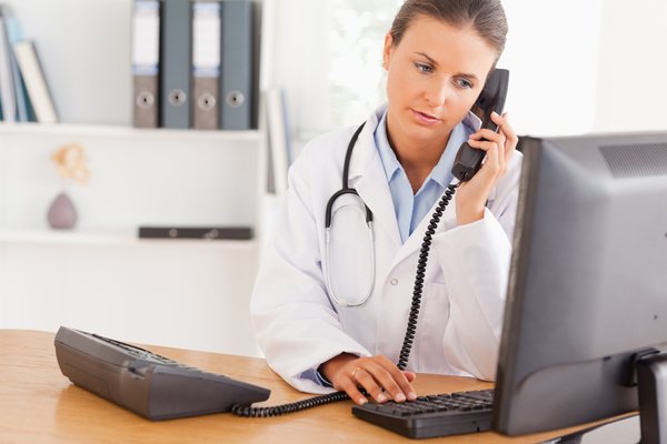 A doctor at The Medical Canggu clinic answering a patient call, providing professional and reliable healthcare service in Canggu.